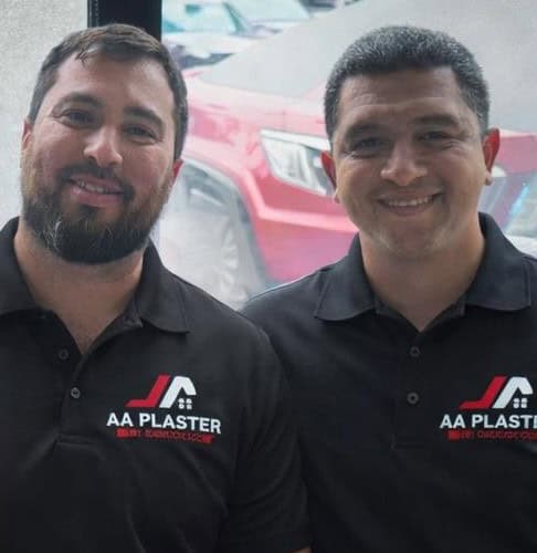 The two partners behind A&A Plaster & Drywall in branded polos
